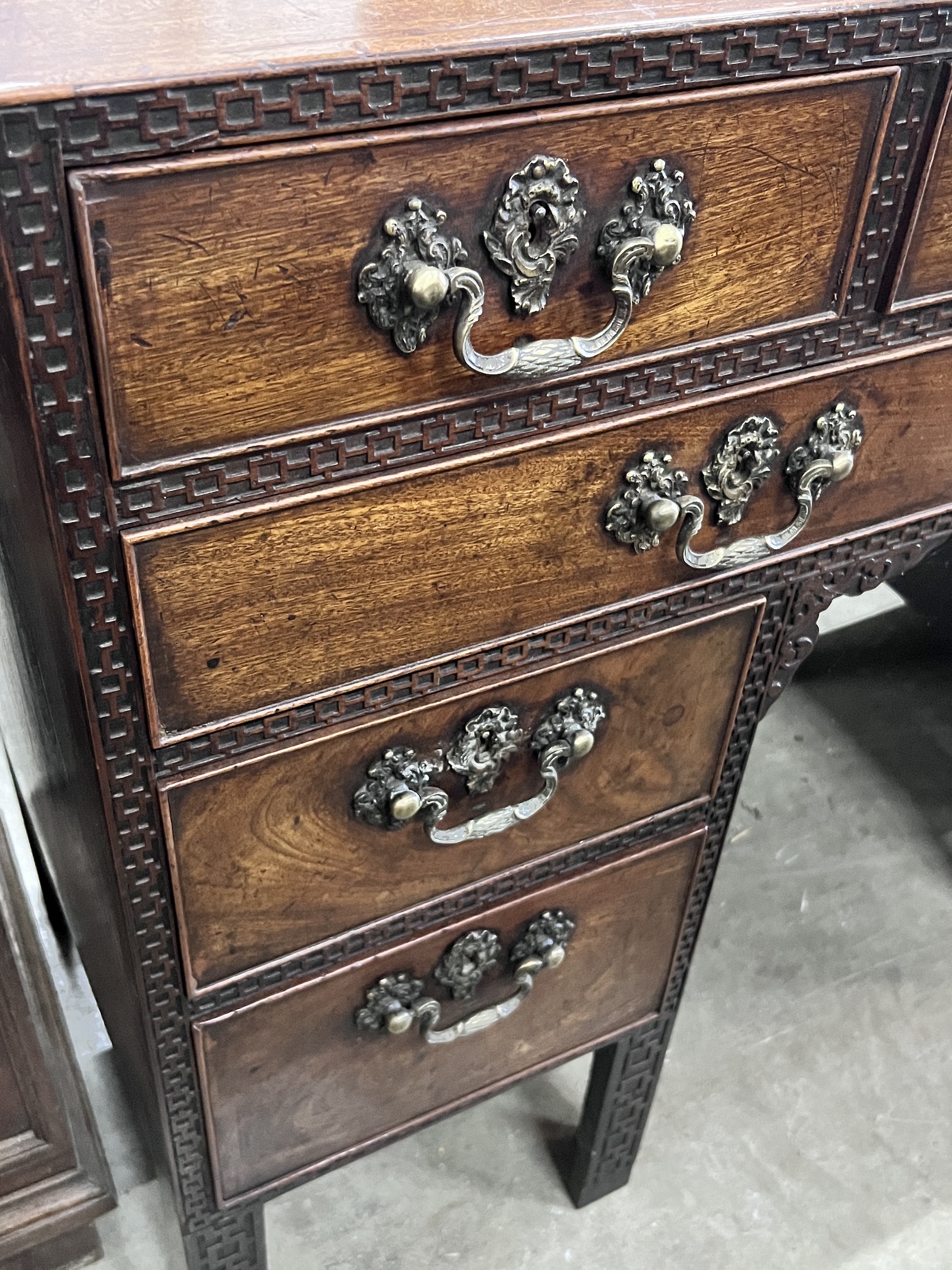 A George III Chippendale style mahogany blind fret kneehole desk, width 112cm, depth 48cm, height 87cm.